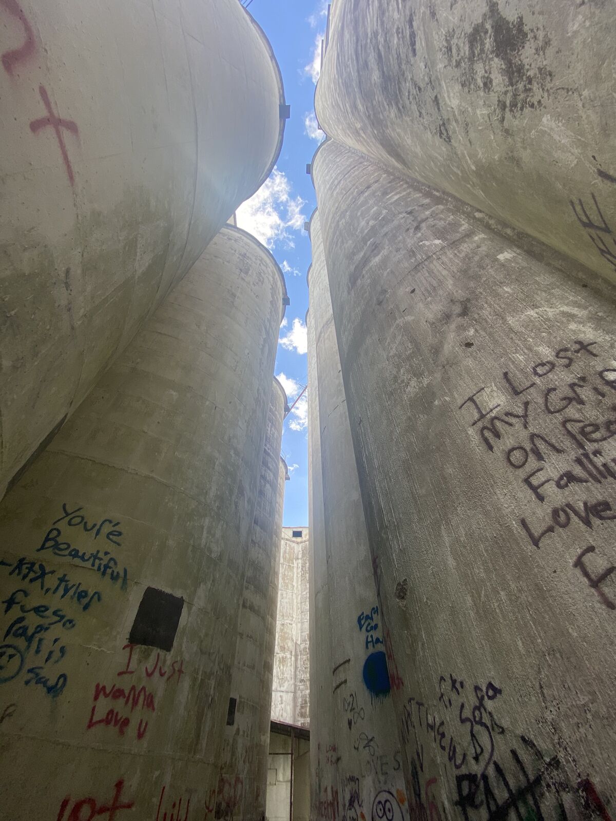The narrow passage between two tall concrete silos