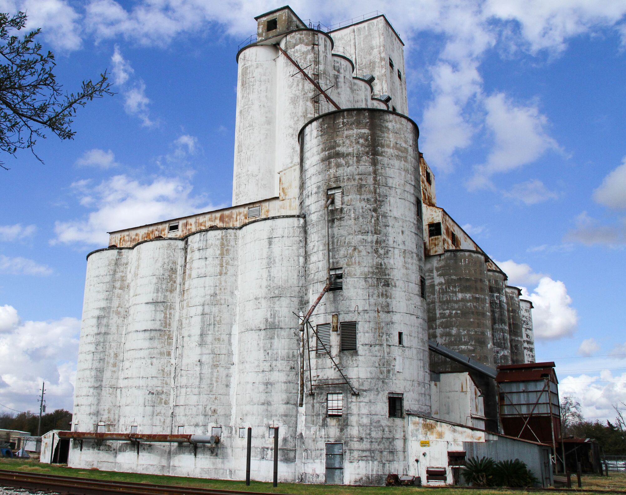 The three white rice dryers under a blue sky