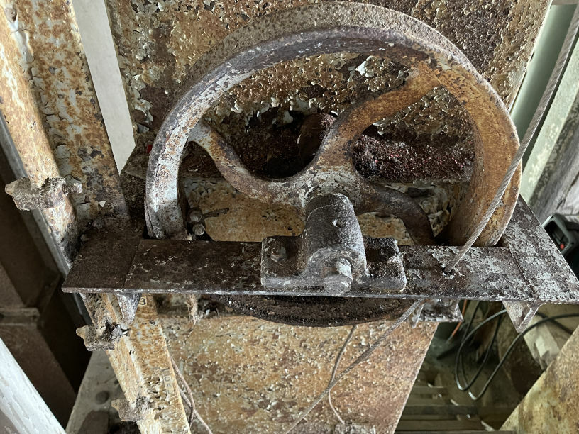 A rusted pulley wheel of the drying machinery